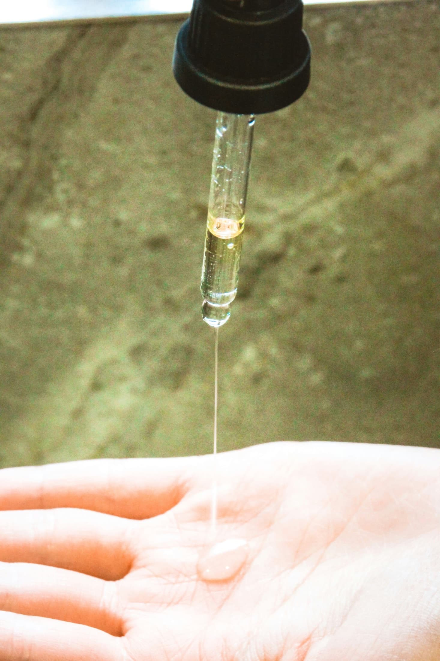 Applying a Verre serum to the back of the hand